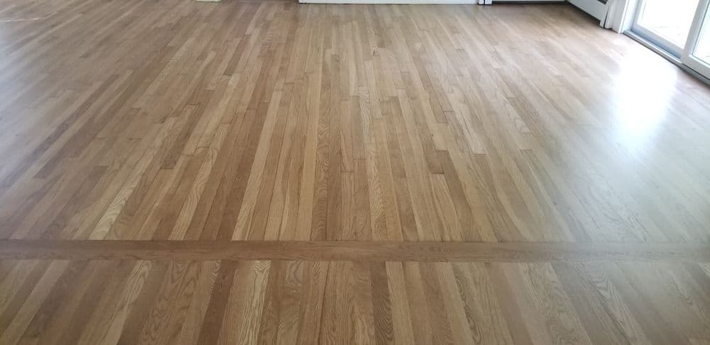 Polished hardwood flooring with natural wood grain patterns in a spacious room.